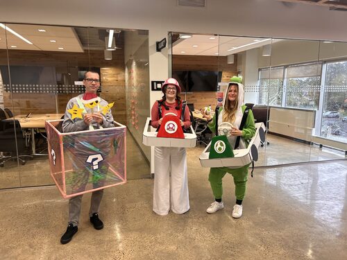 Anna in a Halloween costume with coworkers
